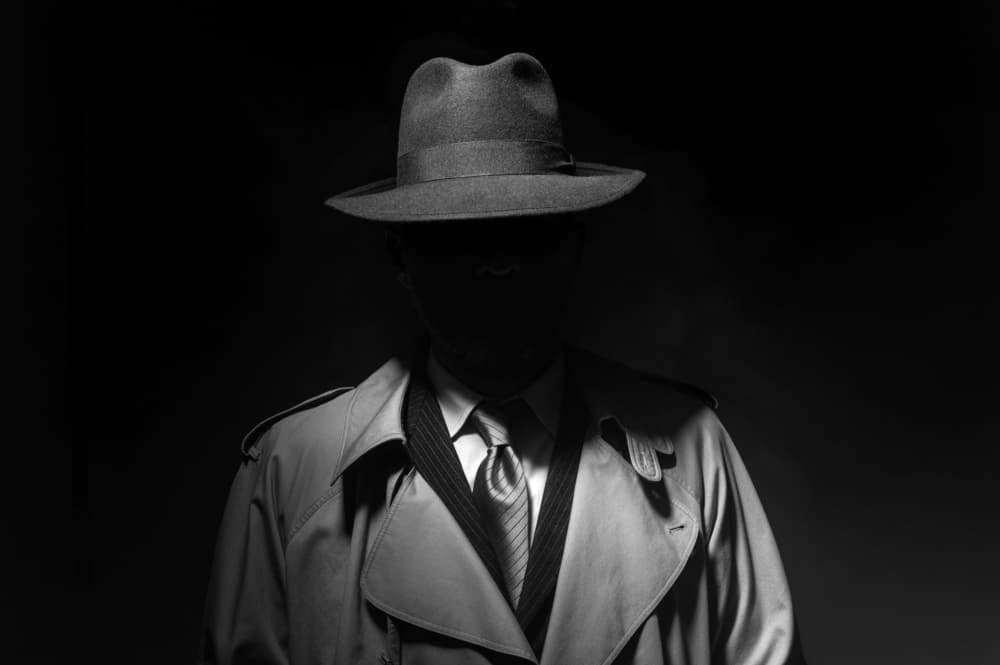 Faceless mysterious man in black background.
