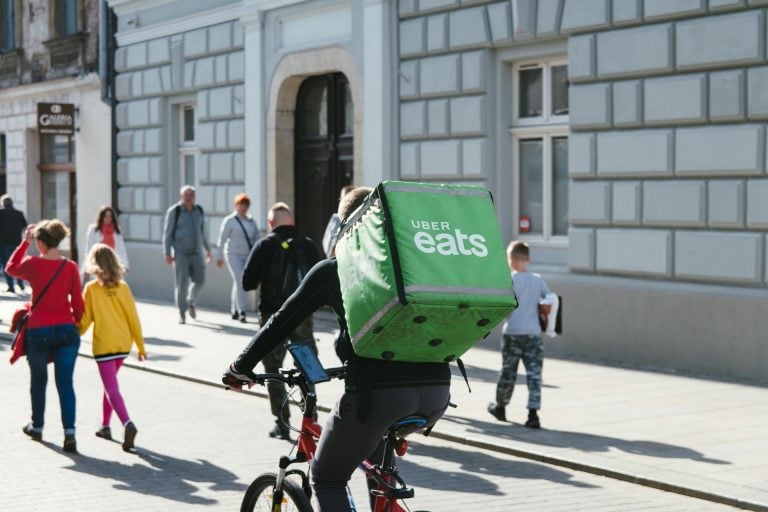 In this photo - UBER eats driver delivering the food.